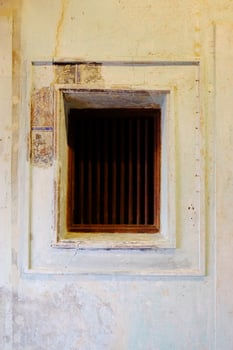 Old wrought iron window with ancient painted pattern on vintage and rustic grunge concrete wall interior of Chinese house photo