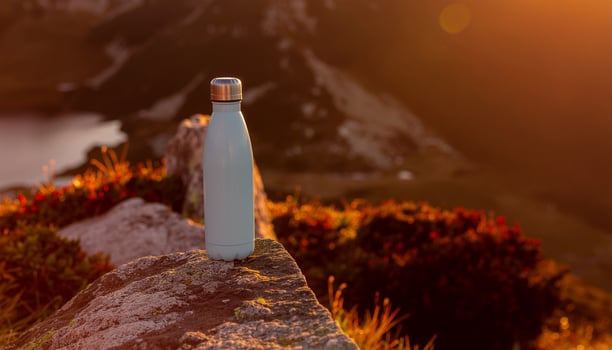 Blue Alkaline Bottle on River Stone photo