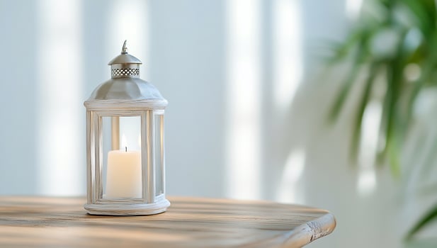 White lantern candle on wood table, sunlit room photo