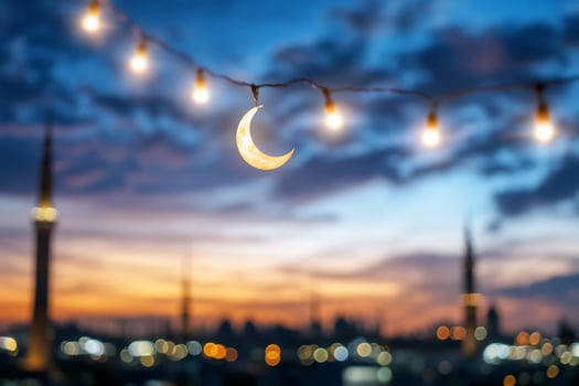 Crescent moon lights festive cityscape sunset photo