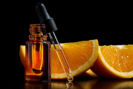 Organic vitamin C serum arranged with fresh orange slice for a soothing and vibrant cosmetic display photo