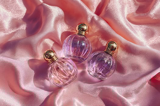 Perfume bottles on pink satin photo