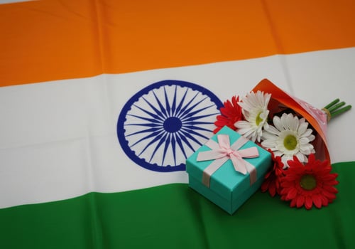 Indian flag with a gift box and flowers, celebrating independence day photo