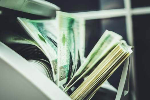 Cash is Counted in a Bank's Money Counter Machine During Business Hours photo