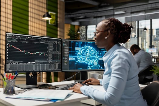 Trader in office using neural network AI models to enhance predictive accuracy of stock market movements. Prop firm employee leveraging artificial intelligence to optimize trading strategies photo
