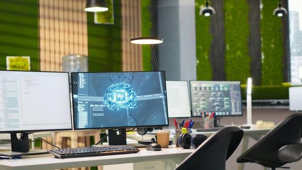 Empty startup office with AI neural networks program running on PC monitors used by developers. AI company workspace computers leveraging deep learning technology, handheld camera shot photo