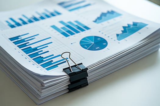 Pile of business reports and financial data analysis charts for review and strategic planning document stack photo