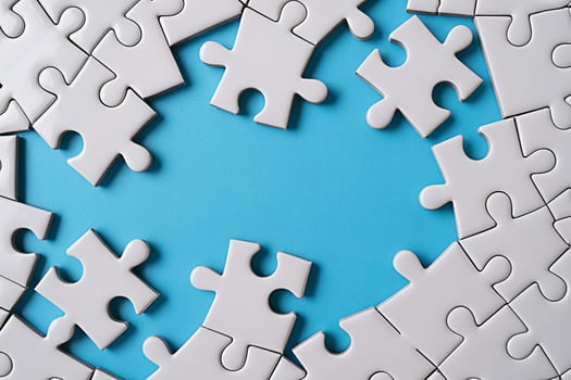 White jigsaw puzzle pieces on blue background strategy teamwork solution concept complete the puzzle game photo