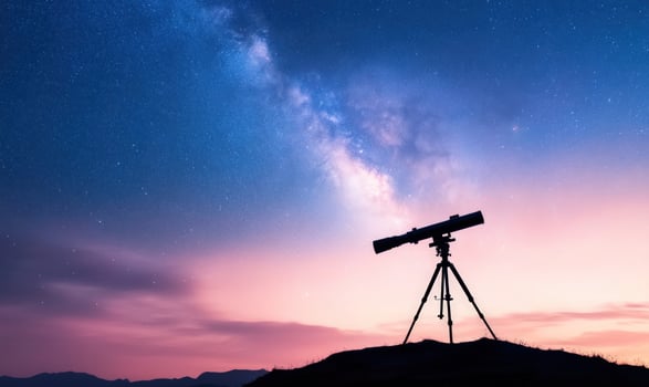 A telescope silhouetted against the Milky Way galaxy in a starry night sky. photo