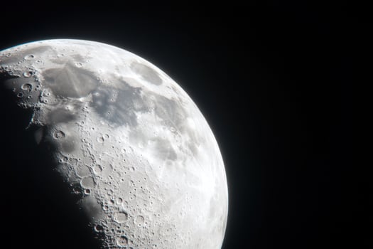 A close-up view of the moon in the night sky, showing its craters and surface details. photo