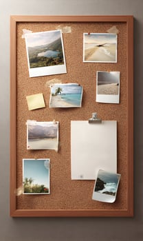Travel mood board with vacation photographs pinned memories on cork board blank paper note for creative design projects showcasing summer holiday planning inspiration and photo