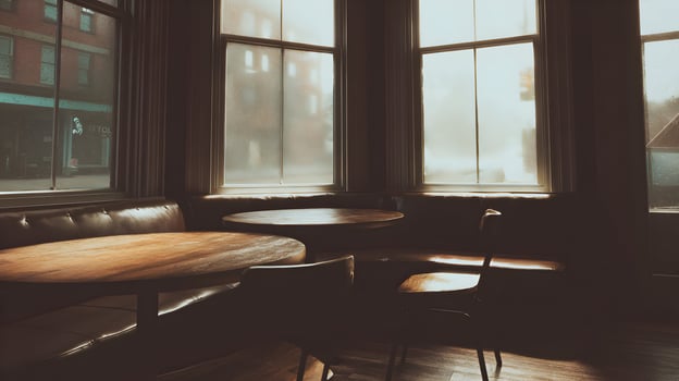 Atmospheric cafe interior with bright windows inviting sunlight creating a warm and intimate ambiance ideal for cozy moments and relaxed gatherings with modern chairs and wooden photo