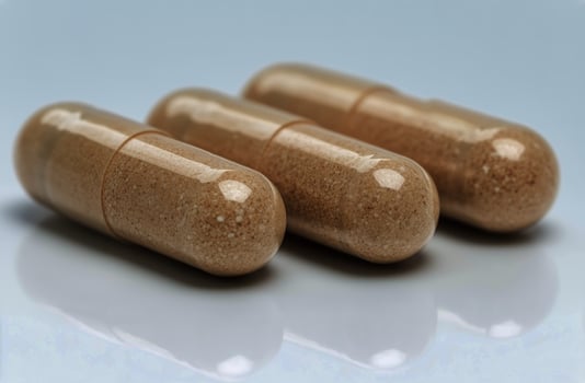 Herbal Capsules Displayed on a Clean Surface Highlighting Natural Ingredients and Their Potential Benefits photo