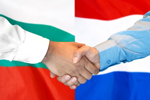 handshake on Bulgaria and Netherlands flag background. photo