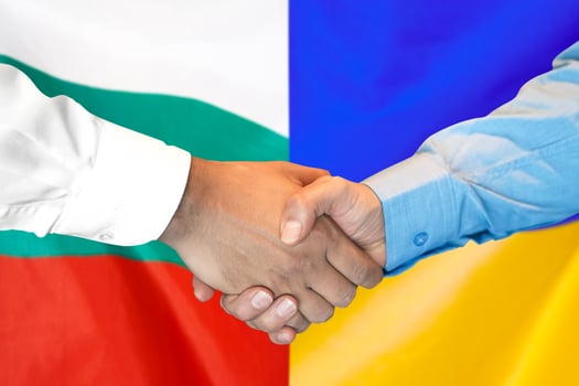 handshake on Bulgaria and Ukraine flag background. photo