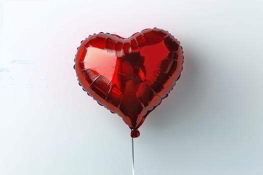 Red Heart-Shaped Balloon Floating Against a Plain Background Showcasing Love and Celebration photo
