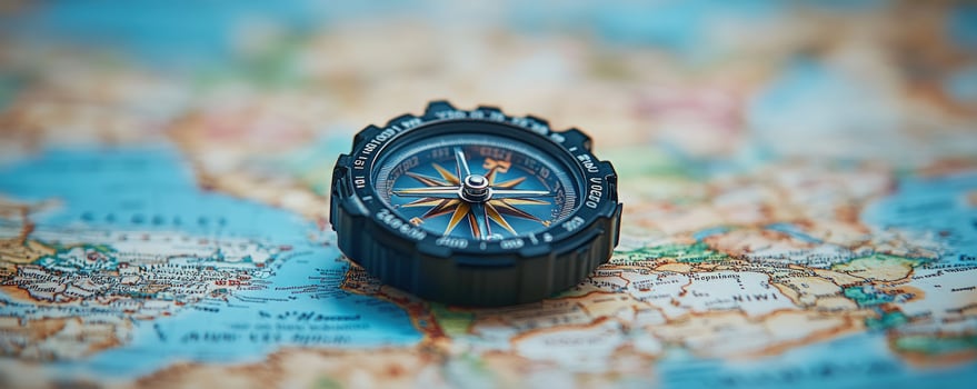 Close up of a compass resting on a map. photo