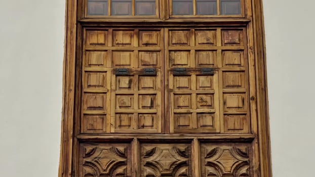 A wooden window with decorative carvings on it photo