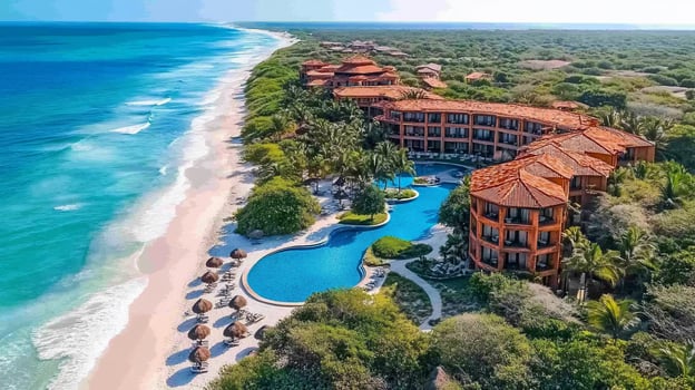 Aerial view of a luxury resort with a swimming pool and beach. photo