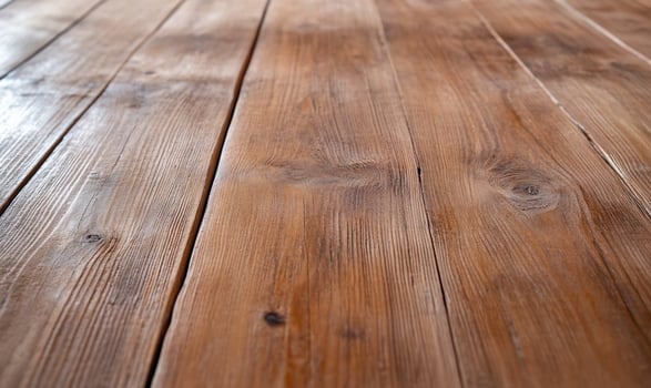 A close up of a wooden floor with some stains photo