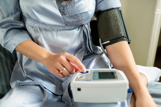 A woman measures her blood pressure with a tonometer photo