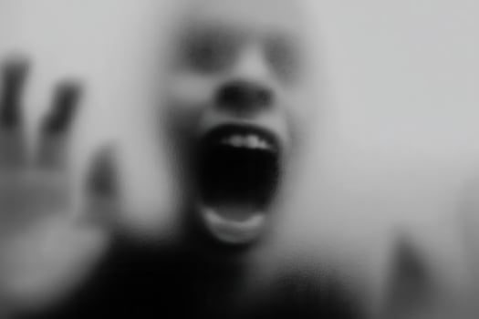 A blurry image of a person with their mouth open photo