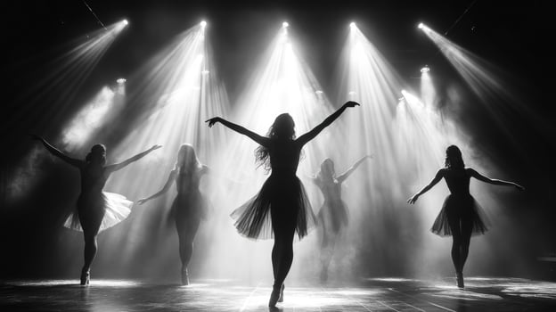Silhouettes of five ballerinas in a dramatic performance on stage, illuminated by bright spotlights. photo