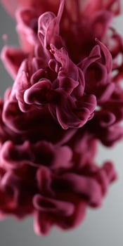 A red liquid is being poured into a glass photo