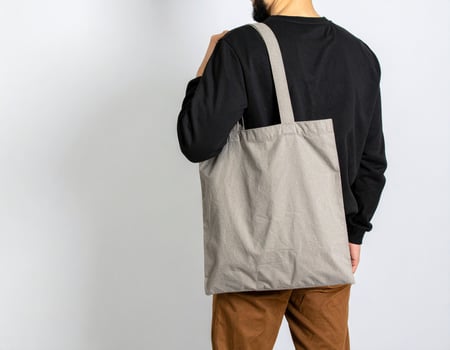 Man carrying grey tote bag photo