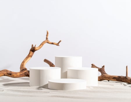White Cylindrical Display Stands on Sand photo