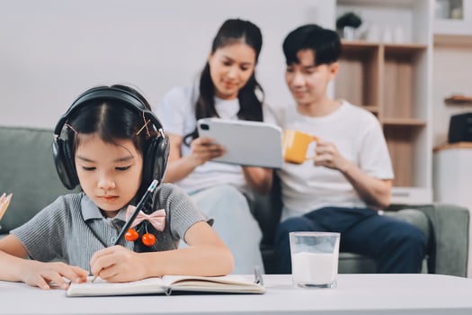 Child studying at home with family photo