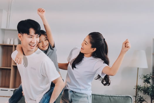 Happy family playing in living room photo