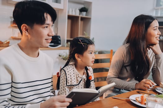 Family sitting at dining table photo