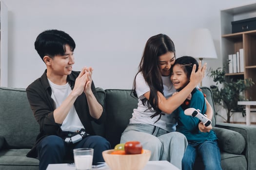 Family gaming together on the couch photo