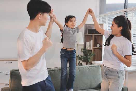 Family dancing in living room photo