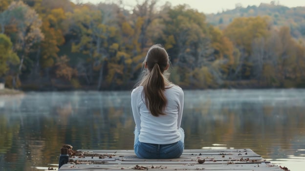 Woman contemplating autumn lake landscape scenery photo