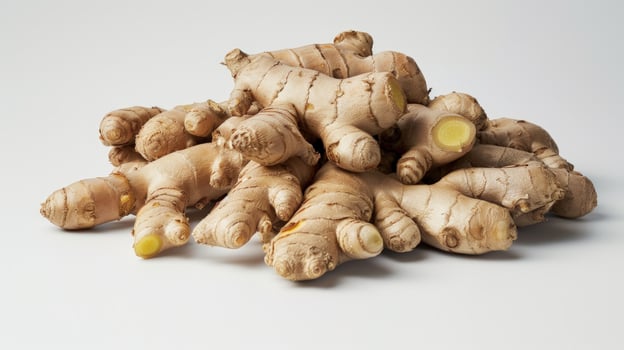 Fresh ginger root pile close up still life on white background photo