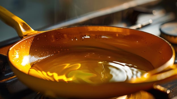 Golden oil simmering in frying pan on stove for culinary use photo