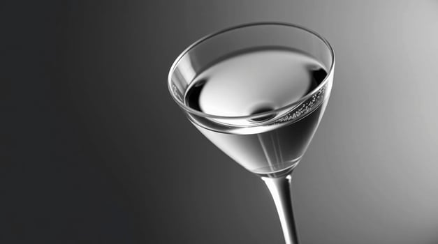 A glass of water with a drop of liquid in it photo