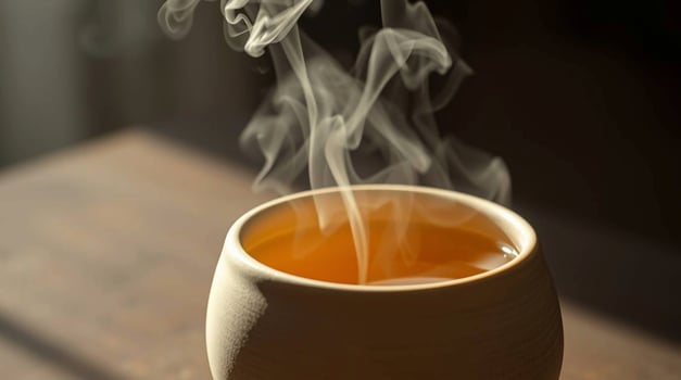A cup of tea with smoke coming out of it photo