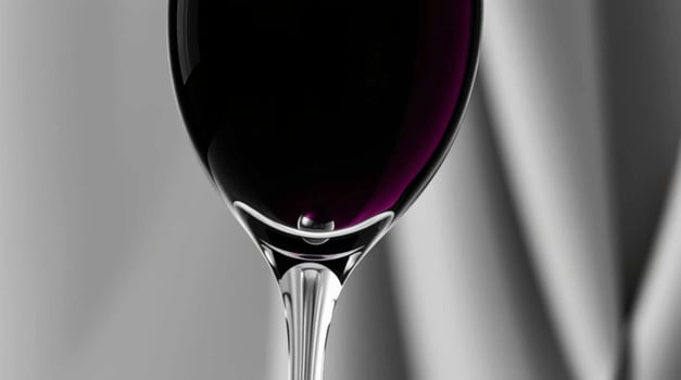 A wine glass with a black liquid in it photo