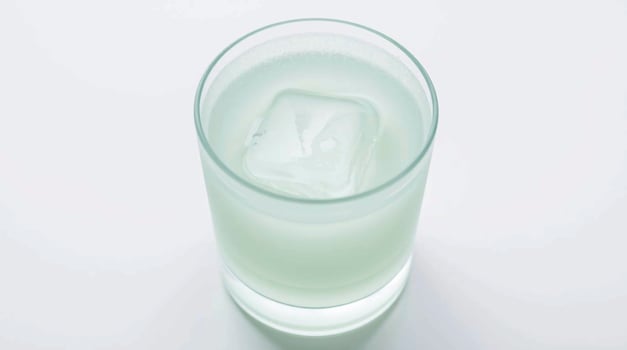 Pale Green Beverage with Ice Cube in Glass Beverages photo