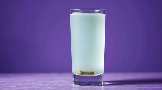 A blue drink with a lime in it photo