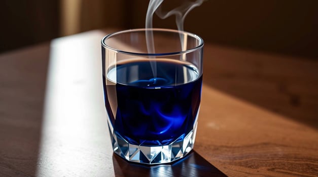 Steaming Blue Liquid in a Glass Beverages photo
