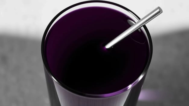 A glass of purple liquid with a straw in it photo