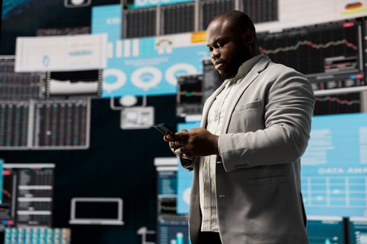 Black male business leader in a digital environment focused on charts, working on strategic planning analysis for profitability and performance. Insightfulness and fintech forecasting. photo
