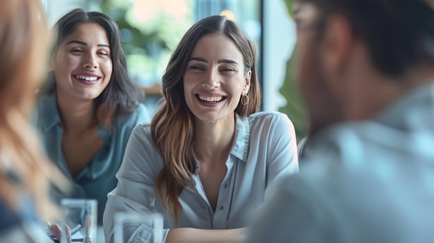 Diverse group of people enjoying conversation and smiling indoors photo