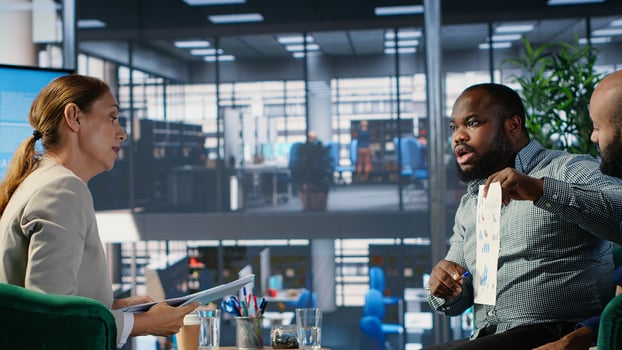 Diverse company leaders discuss business development with performance data and strategic thinking to improve career growth, executive planning and professional decision making. Camera B. photo