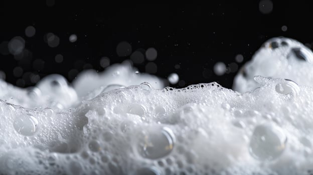 White foamy suds abstract texture on dark background photo