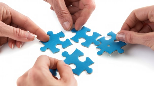 Hands solving blue puzzle pieces together representing teamwork and cooperation photo